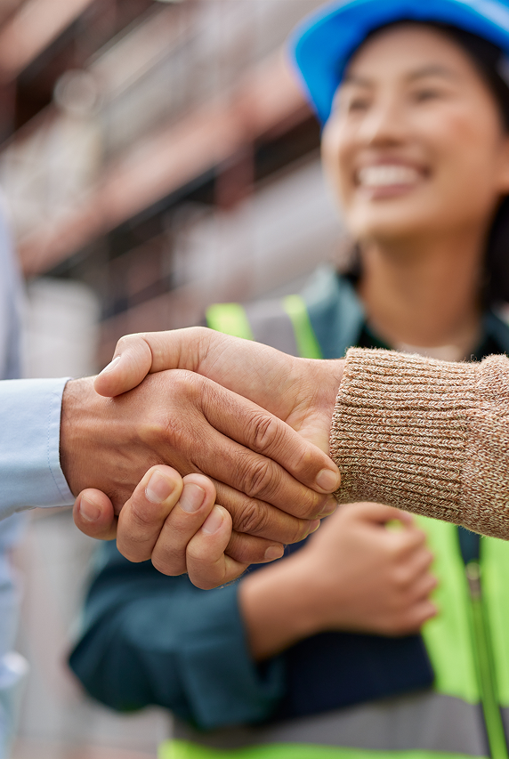 People shaking hands with person looking on